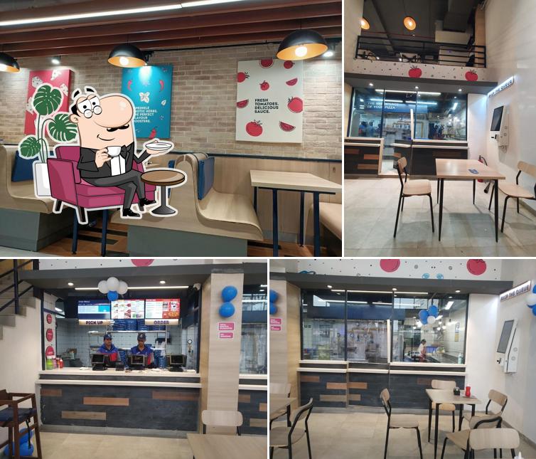 Take a seat at one of the tables at Domino's Pizza Sarkanda, Bilaspur