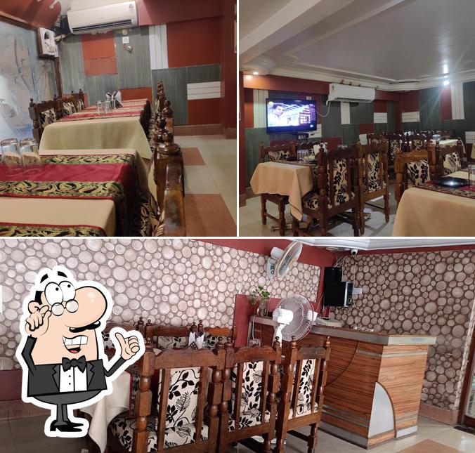 Take a seat at one of the tables at Aroma Restaurant