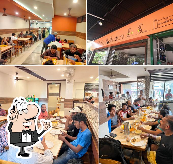 Take a seat at one of the tables at Alankar Family Restaurant