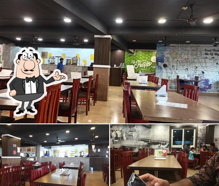 Take a seat at one of the tables at Thalassery Restaurant