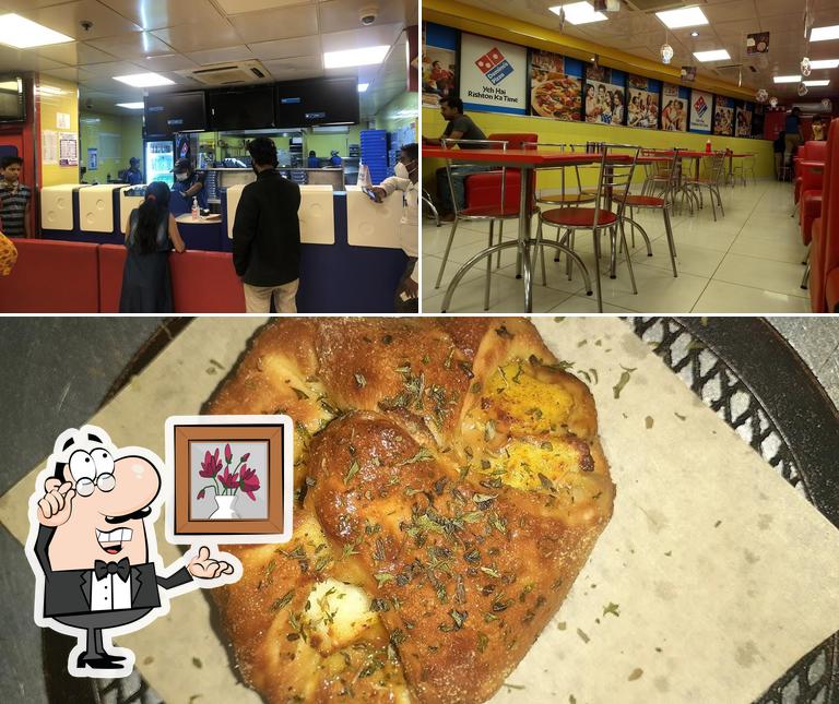 Take a look at the image depicting interior and food at Domino's Pizza Rajendra Nagar, Hubballi-Dharwad