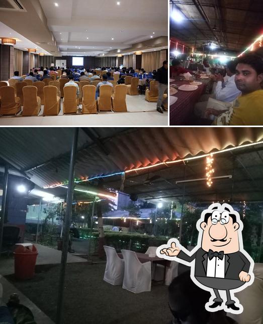 Take a seat at one of the tables at Yash Garden Family Restaurant & Bar