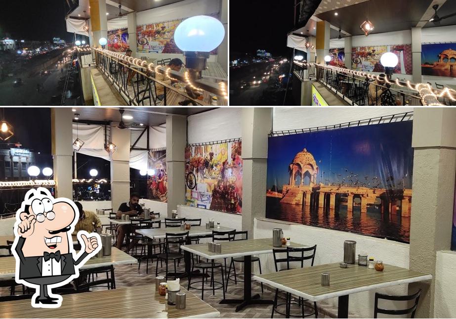 Take a seat at one of the tables at Om Pure Veg Rajasthani Gujarati Spl. Thali