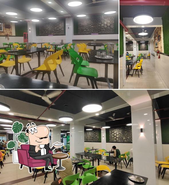 Take a seat at one of the tables at Kini Cafeteria