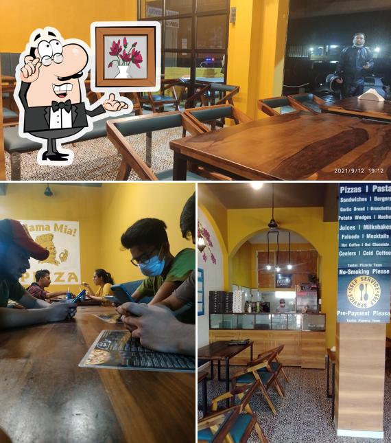 Take a seat at one of the tables at Tantos Pizzeria