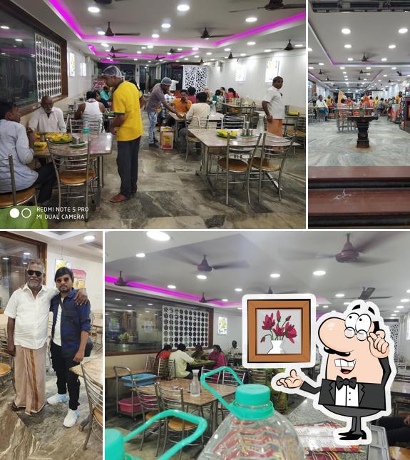 Take a seat at one of the tables at HOTEL MEGA SANGEETHA