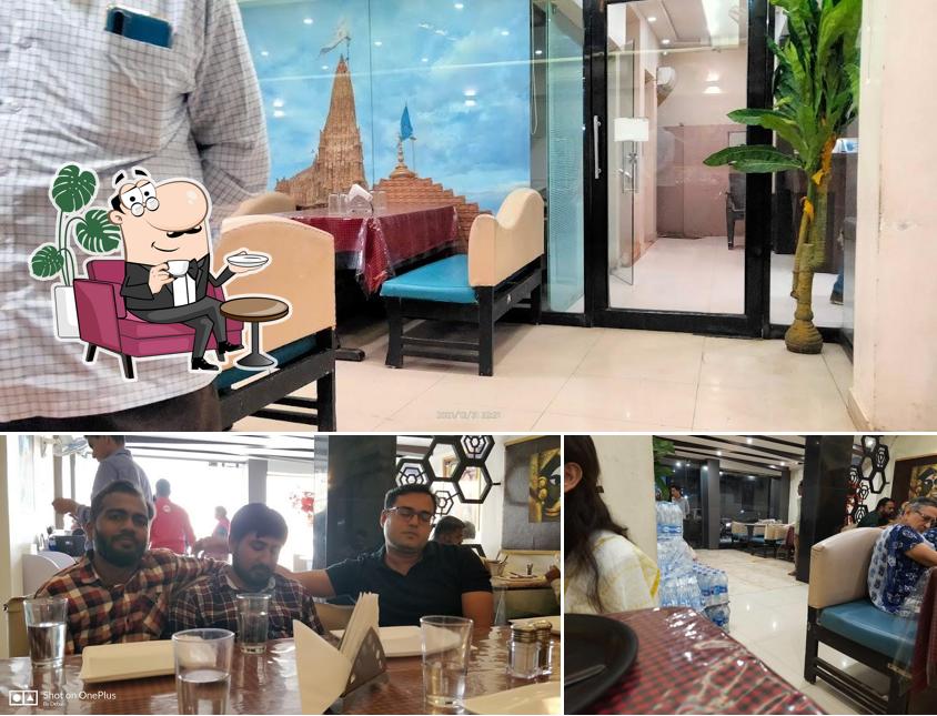 Take a seat at one of the tables at Charmi Restaurant