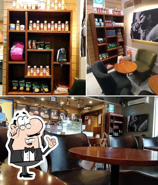 Take a seat at one of the tables at Café Coffee Day