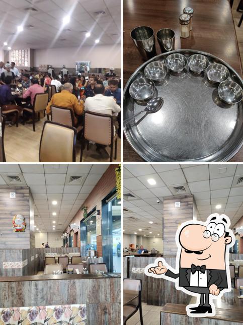 Take a seat at one of the tables at Sasumaa's Multi Cuisine Restaurant & Gujarati Thali