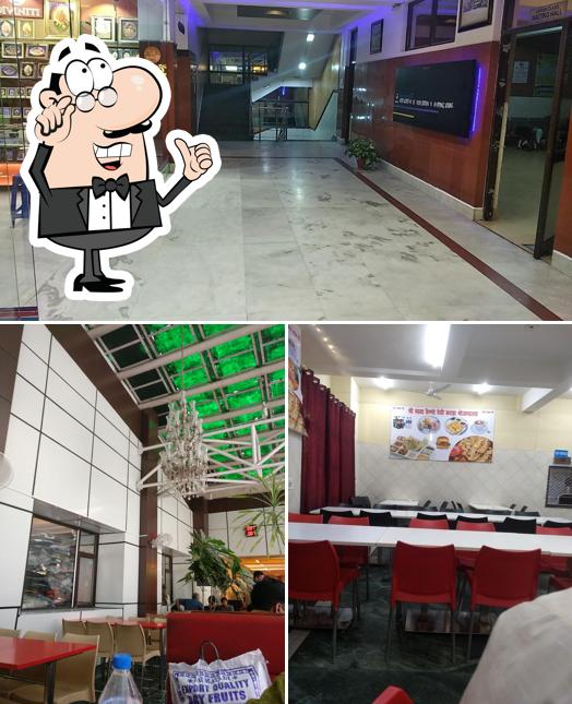 Take a seat at one of the tables at The Vaishnodevi IRCTC Guest House,Food Station & Shopping Lounge