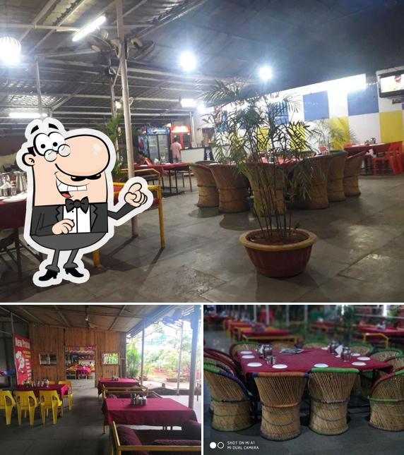 Take a seat at one of the tables at Hotel New Pratap