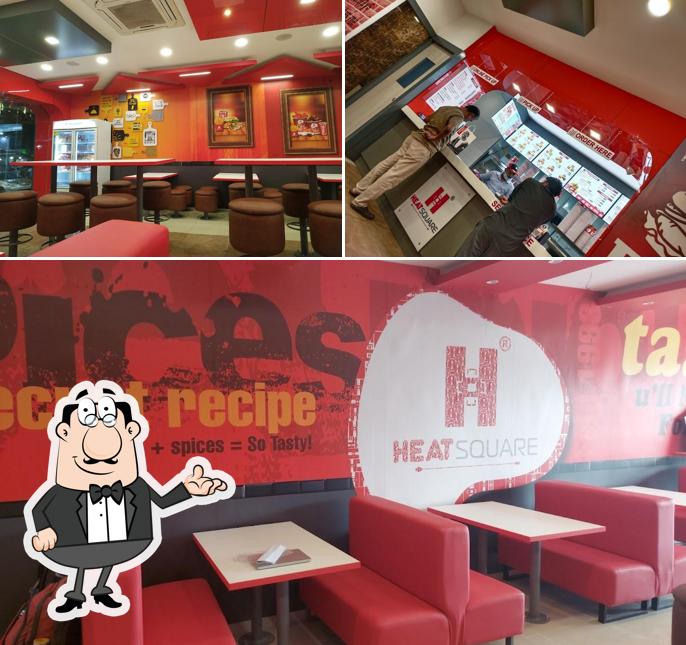 Take a seat at one of the tables at Heatsquare Restaurant Tiruppur