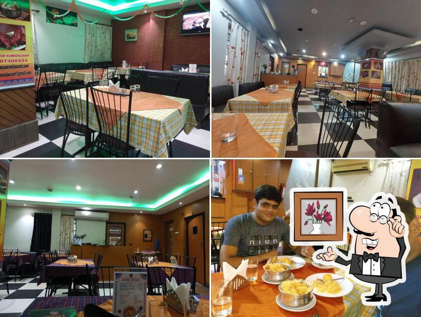 Take a seat at one of the tables at Ananya's Multicuisine Restaurant