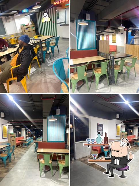 Take a seat at one of the tables at Pizza Hut Hotel Maple Retreat, Manali