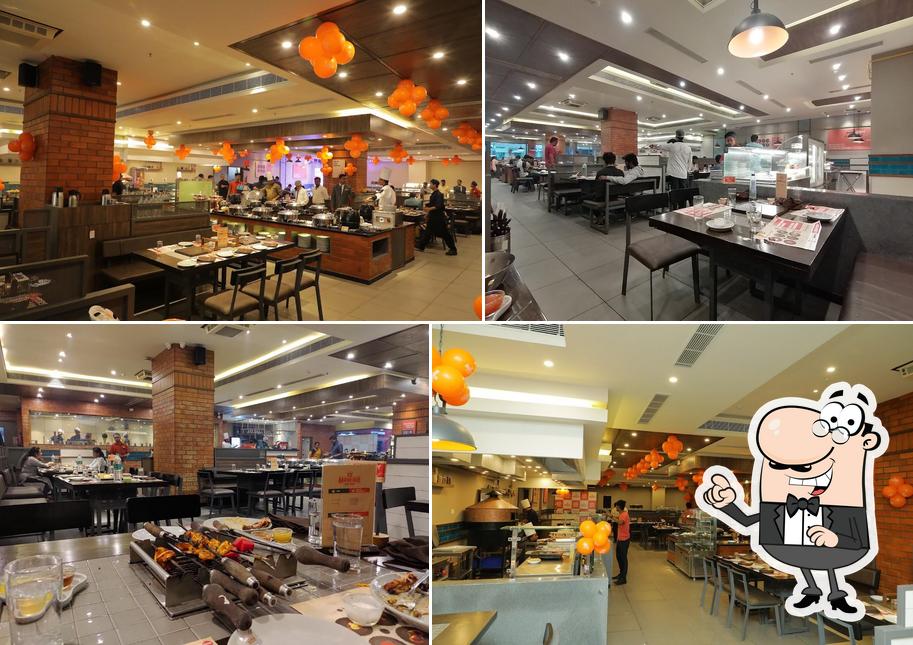 Take a seat at one of the tables at Barbeque Nation - Coimbatore - Fun Mall