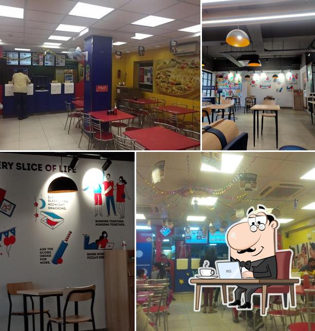 Take a seat at one of the tables at Domino's Pizza Jigani, Bengaluru