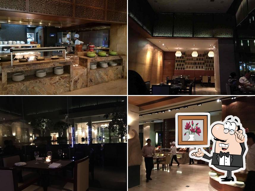 Take a seat at one of the tables at Okra - Jaipur Marriott Hotel