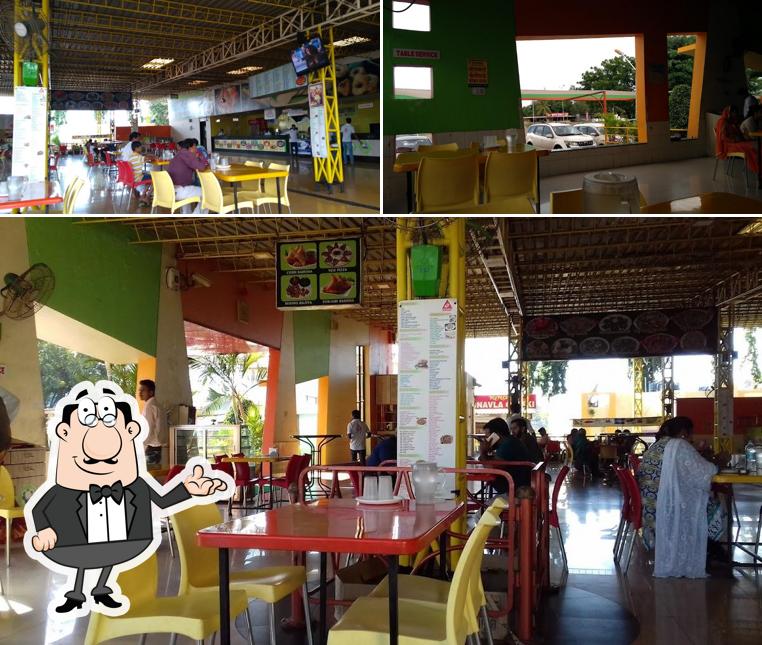 Take a seat at one of the tables at Hotel Daulat Refreshment