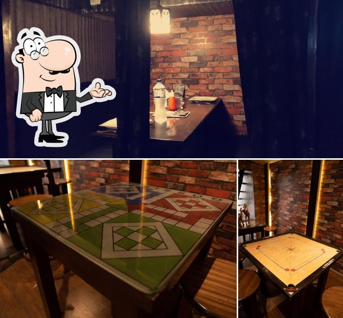 Check out the picture displaying interior and dining table at Gossip Cafe