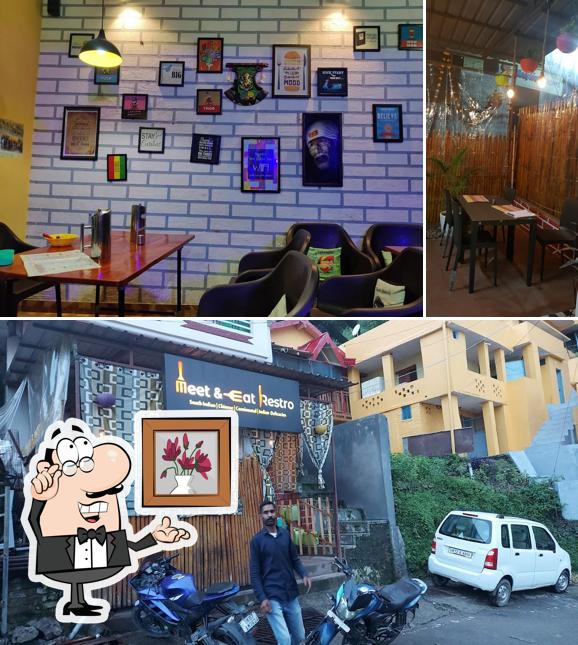 Take a seat at one of the tables at Meet & Eat Restro, Pauri