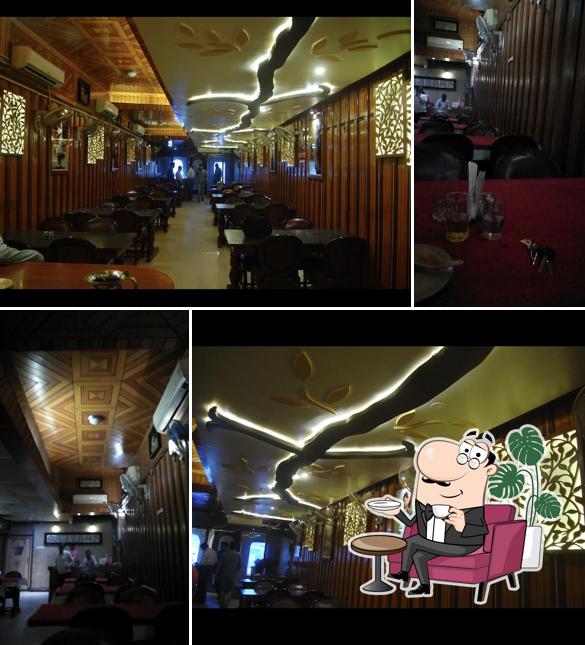 Take a seat at one of the tables at Arpan Restaurant Cum Bar