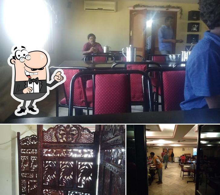 Take a seat at one of the tables at Vasundhara Restaurant