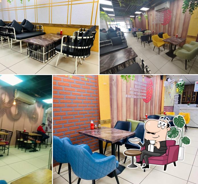 Take a seat at one of the tables at Pizza Country Nawanshahr