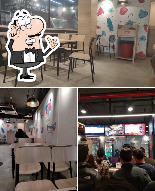 Take a seat at one of the tables at Domino's pizza