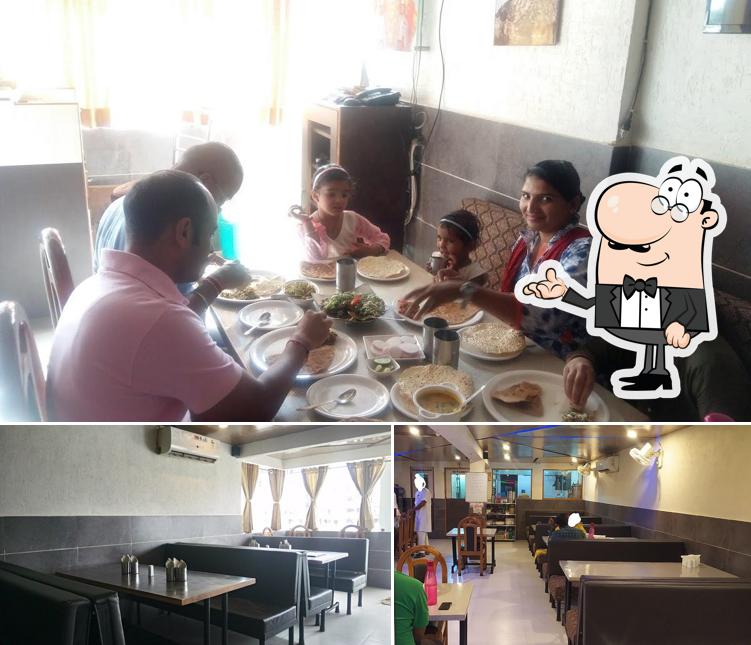 Take a seat at one of the tables at Shree Jaymal Fatta Restaurant