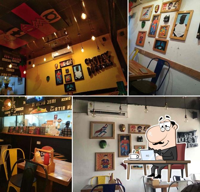 Take a seat at one of the tables at Cheesy Juicy Burger
