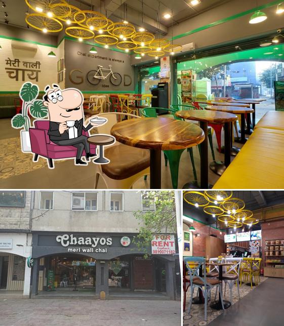 Take a seat at one of the tables at Chaayos Cafe - Community Center, Saket
