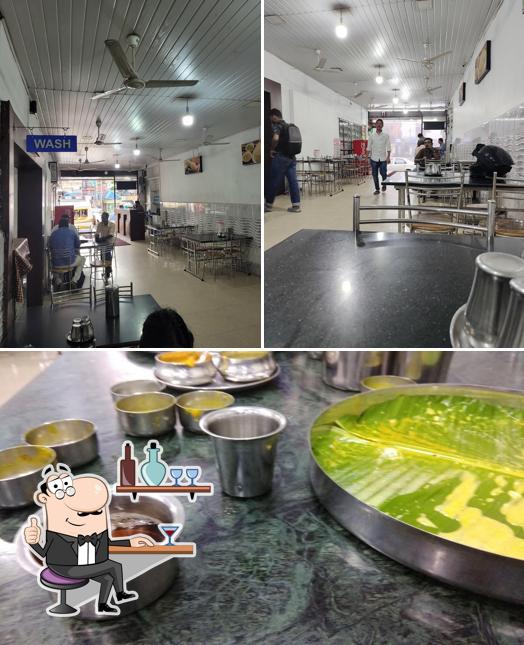 Take a seat at one of the tables at Aryas - Pure Veg