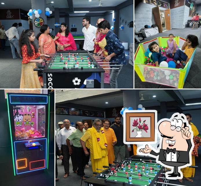 Take a seat at one of the tables at Strikerz Gaming Zone - Sikar