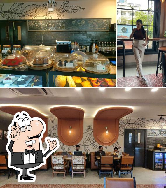 Take a seat at one of the tables at Noir Coffee House - Jaipur