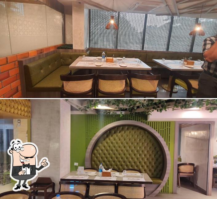 Take a seat at one of the tables at Zaitoon Restaurant, Vellore