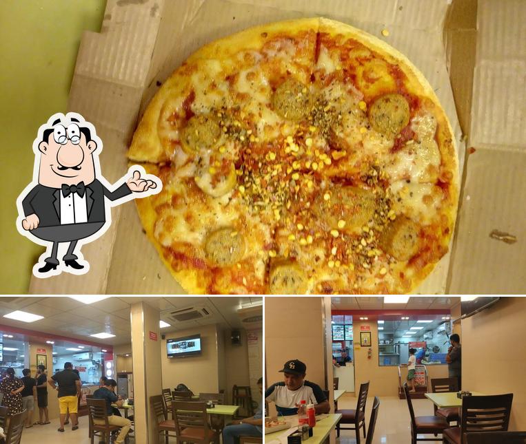 The picture of interior and pizza at Domino's Pizza Benaulim, Goa