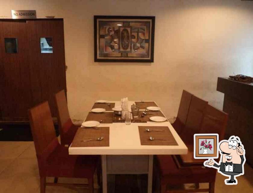 Take a seat at one of the tables at Sankalp Restaurant