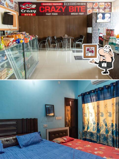 Take a seat at one of the tables at Crazy Bite restaurant rooms Nakodar