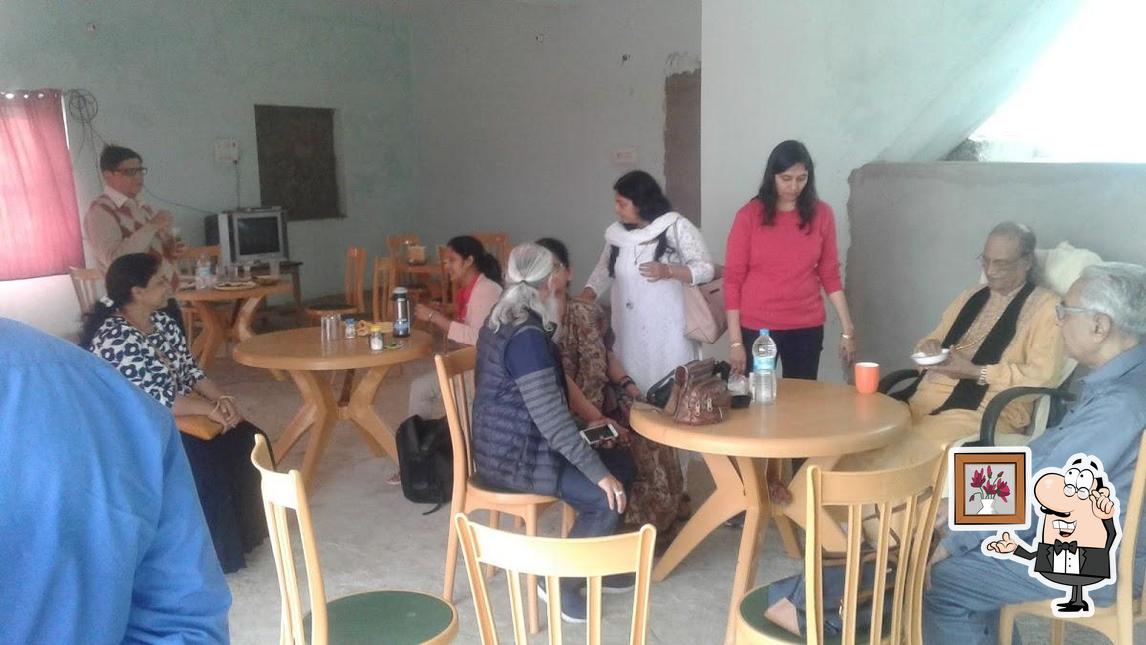Take a seat at one of the tables at Raunak Family Restaurant