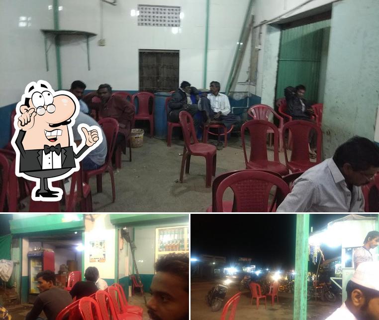 Take a seat at one of the tables at Raju Hotel