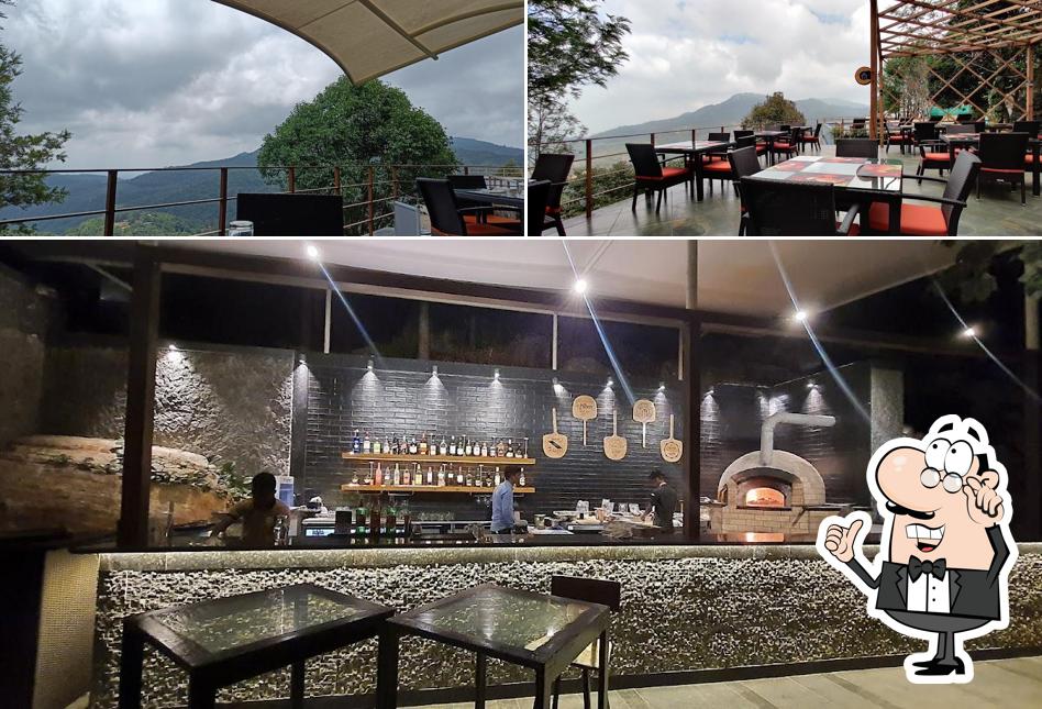 Take a seat at one of the tables at Altitude Global Cuisine Restaurant in Yercaud