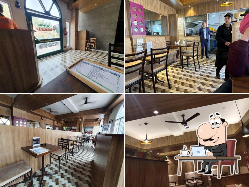 Take a seat at one of the tables at Vithal Kamat Restaurant