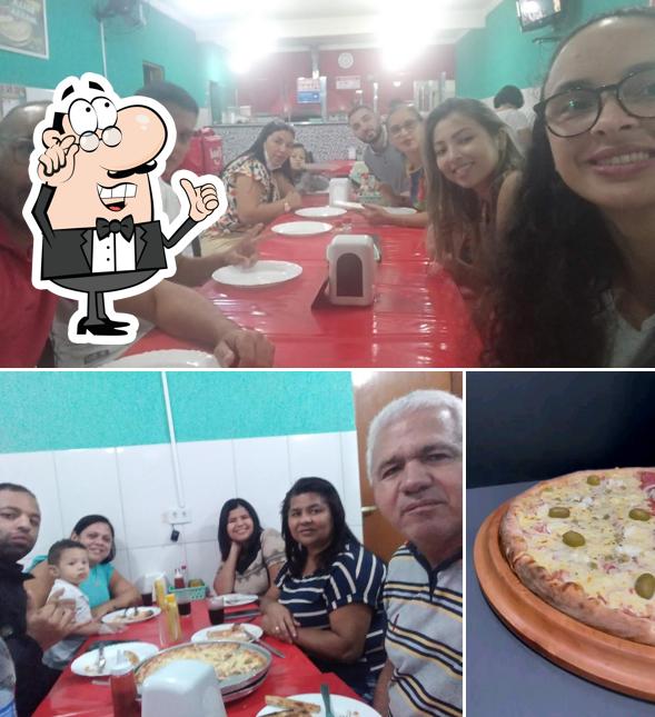 A imagem a Pizzaria Bella massa’s interior e pizza