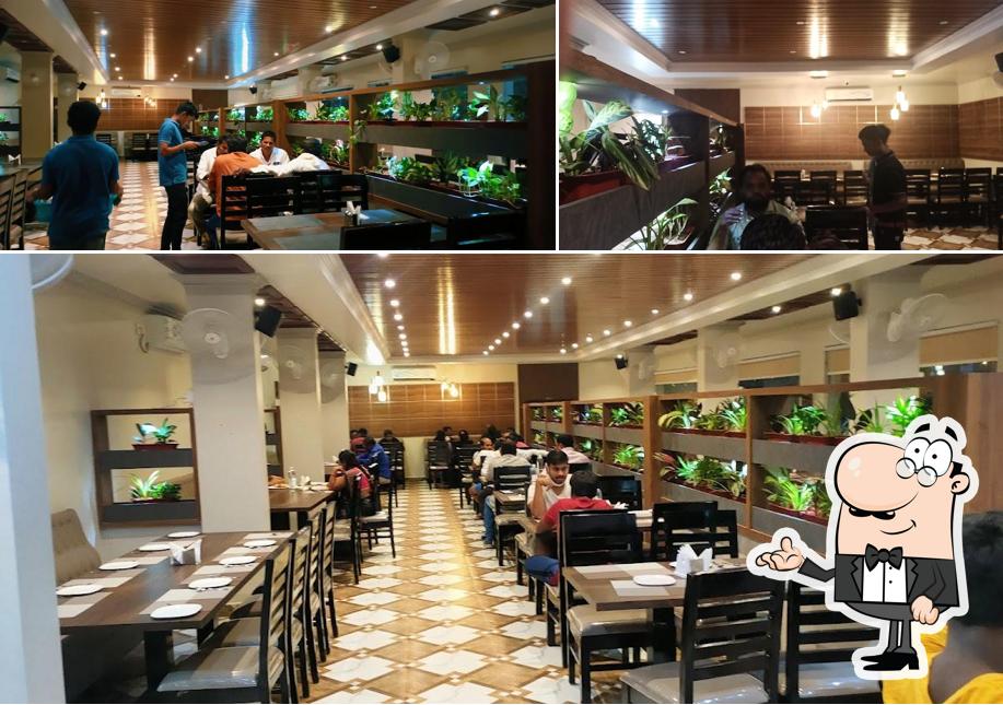 Take a seat at one of the tables at Aroma Restaurant