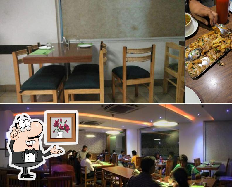 Check out the picture displaying interior and beverage at Eden Vegetarian