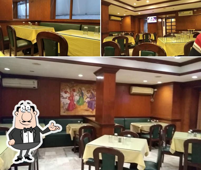 Take a seat at one of the tables at Green View Hotel & Utsav Restaurant