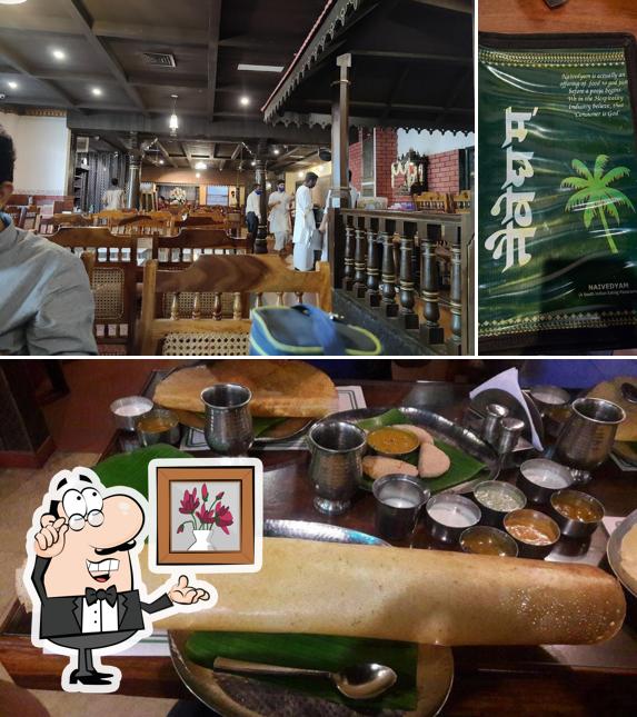 Take a seat at one of the tables at Naivedyam