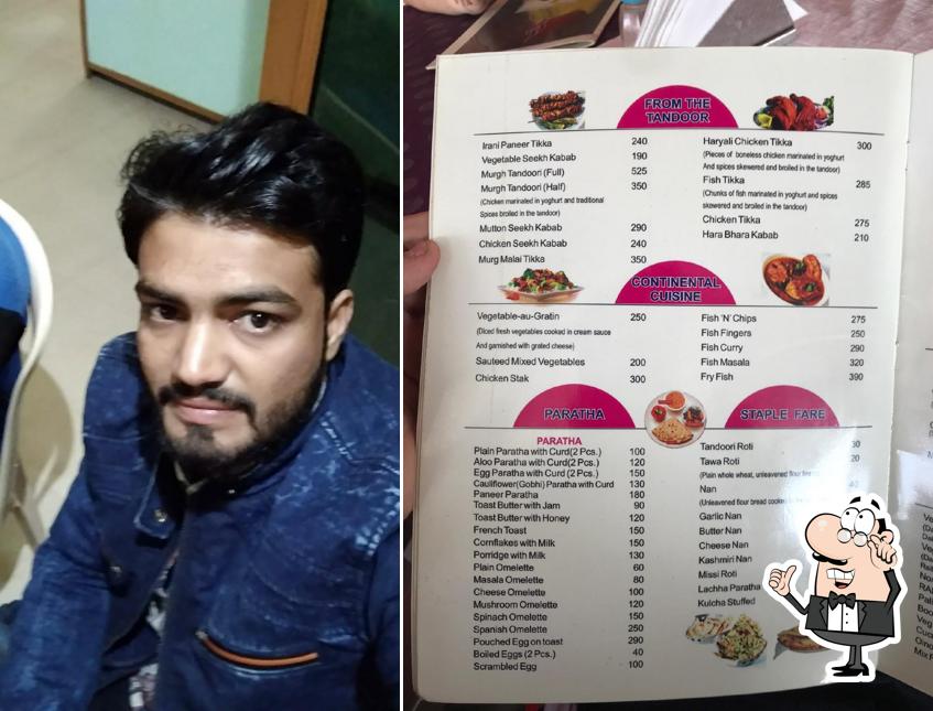 Take a seat at one of the tables at The Gandhi Cafe