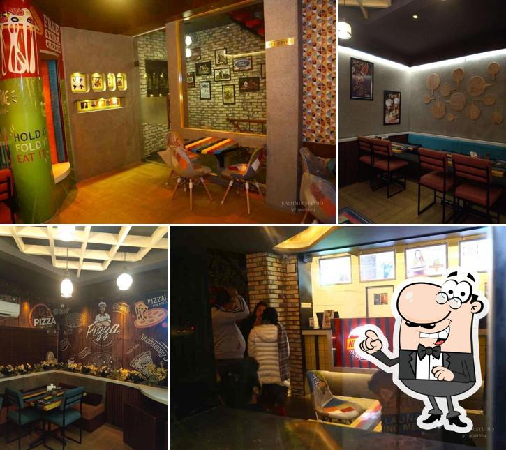 Take a seat at one of the tables at New York Pizza
