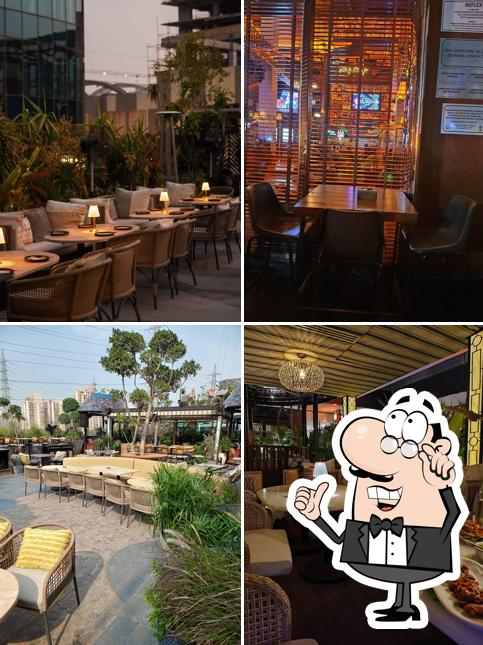 Take a seat at one of the tables at Molecule IFC Best Rooftop Restaurant In Gurgaon